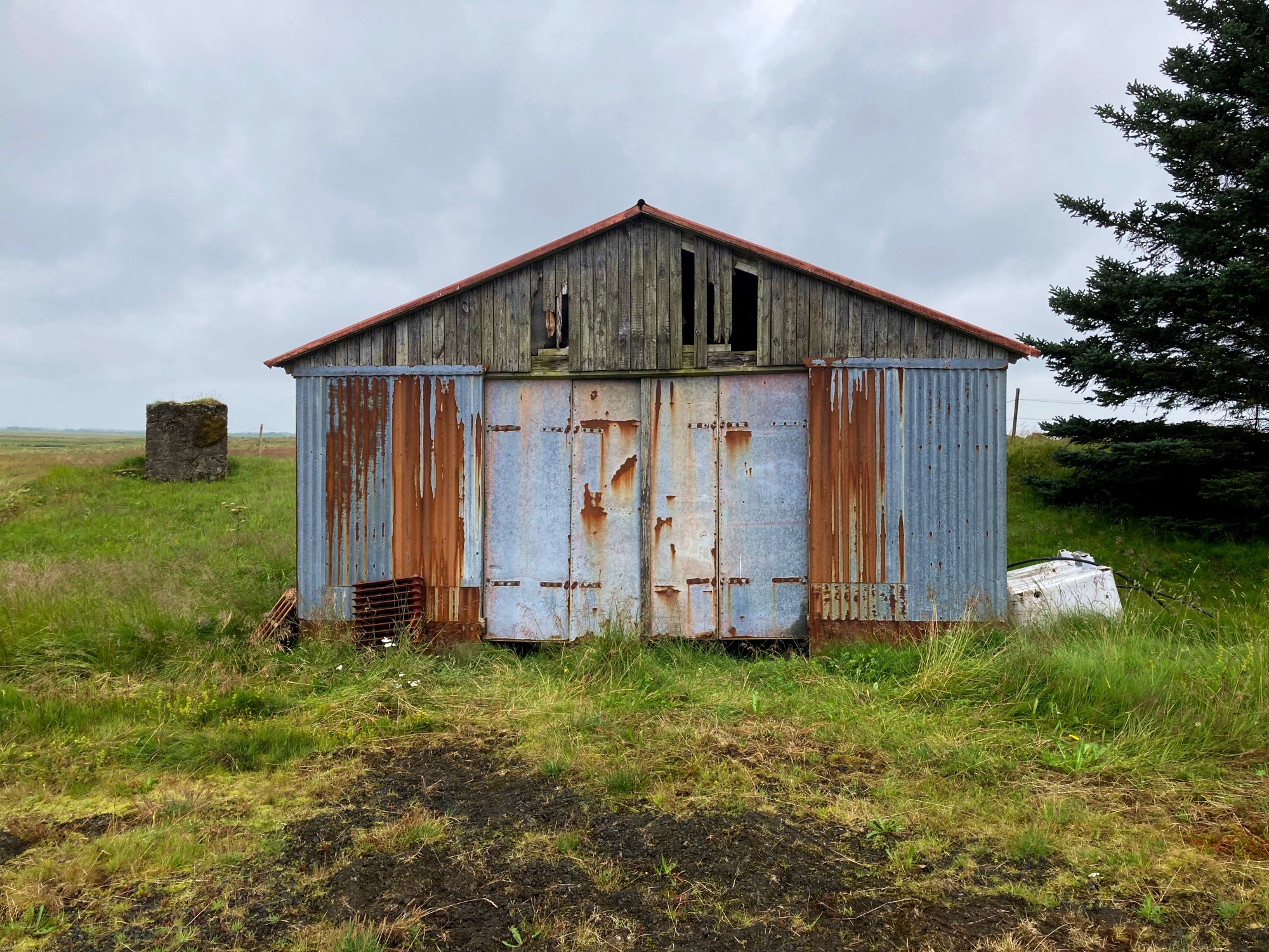 A rusty old shed with some weathered wood.