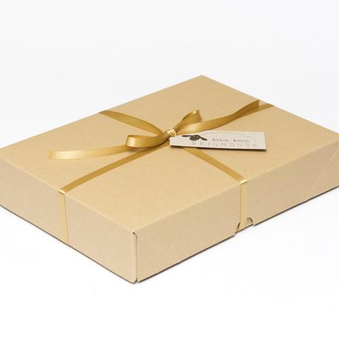Picture shows a closed A4 box tied with gold ribbon.