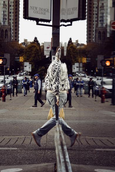 A pedestrian seemingly folds in on himself.