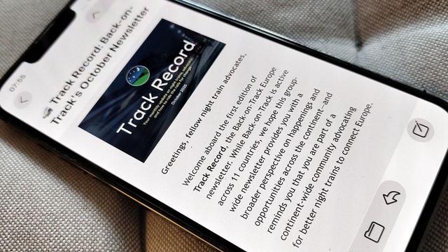 mobile phone on cushion, showing the top of the newsletter