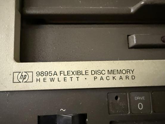 Text beneath a vintage floppy drive reads: 9895A Flexible Disc Memory Hewlett-Packard