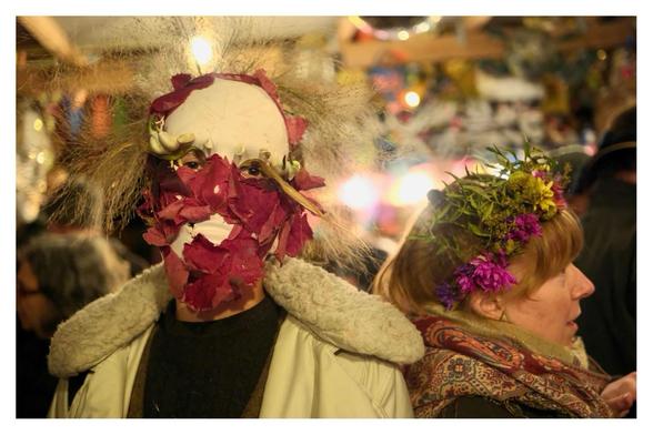 A ‘Who Knows What’ stares into the lens, while a woman with a head dress leans back on it in profile. Seen from behind the bar.