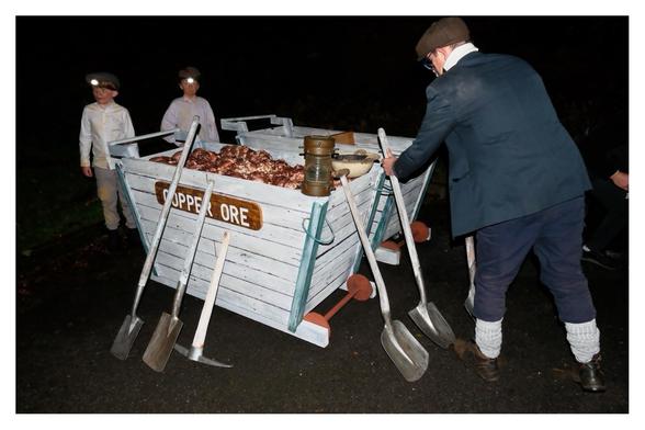 Copper ore minor miners, shovels and picks ready to head down main street.