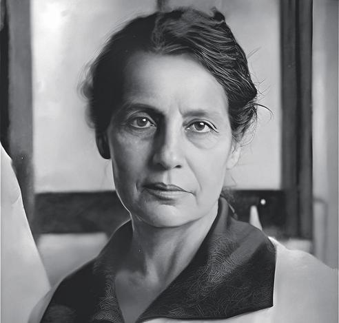 Photograph of Lise Meitner, maybe in her 30s or 40s, with long dark hair tucked behind her head, looking serious but contemplative.