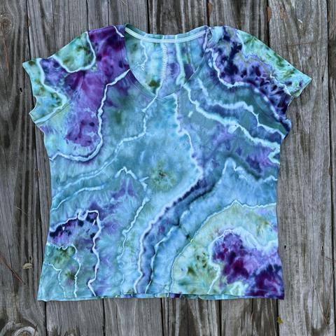 Front of a geode style ice dyed shirt in teals and purples