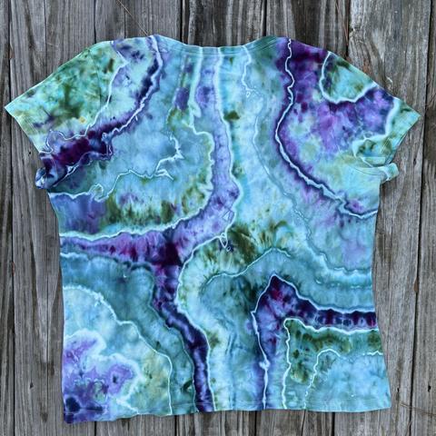 Back of a geode style ice dyed shirt in teals and purples