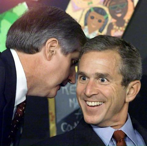 an edited image of George W. Bush being informed about the 9/11 attacks. A member of his entourage is soaking quietly into his ear; instead of the serious look he sported in the original image, Bush's face has been edited into a broad grin.