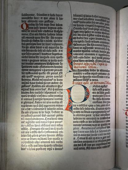we see dramatic lighting across a page from a gutenberg bible / do you know : these books are almost 600 years old ! this one's currently in the vault at lilly library in indiana .. there's only a few dozen copies of this book on the entire planet !