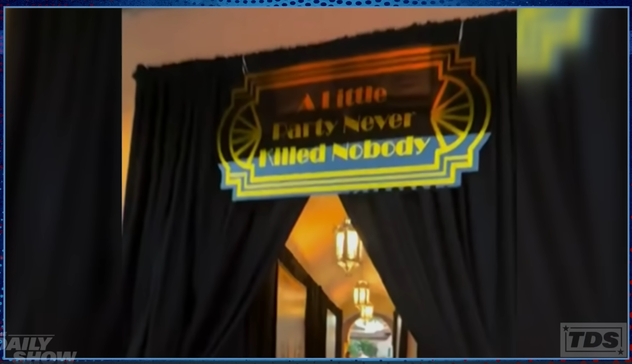 Motto of Donald Trump's 2025 "roaring 20s" themed "Great Gatsby"-style Halloween party over a curtained door, saying "A little party never killed nobody"