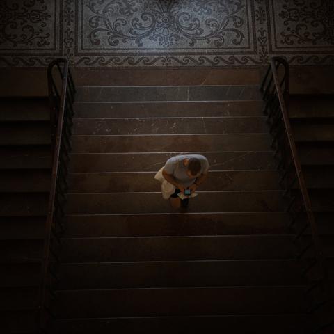 Portrait of a visitor in a staircase museum in Prague, seen from above
