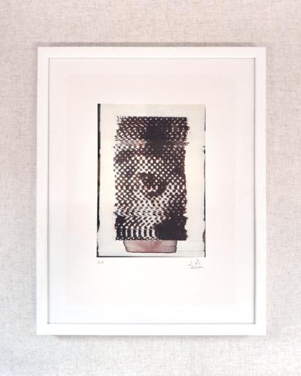 A risograph print which shows a halftone image of an eye which has been distorted on a scanner