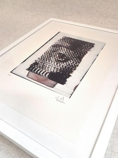 A risograph print which shows a halftone image of an eye which has been distorted on a scanner