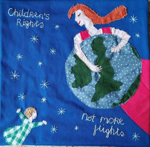 Embroidered square with a child and a woman holding the earth, saying "Children's Rights Not More Flights"