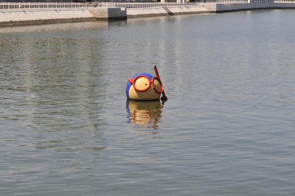 @dutchking A blue and yellow, cartoon-like object is floating on the surface of a body of water. The object is roughly egg-shaped with a bright yellow middle section and a darker blue outer section. Two large, circular, red and white eyes are prominently displayed on the front, along with a red snorkel protruding upwards. The object is positioned in the center of the frame, and its reflection is visible in the water. The water appears calm, and a concrete embankment is visible in the background, slightly out of focus.

Provided by @altbot, generated privately and locally using Gemma3:27b

🌱 Energy used: 0.085 Wh