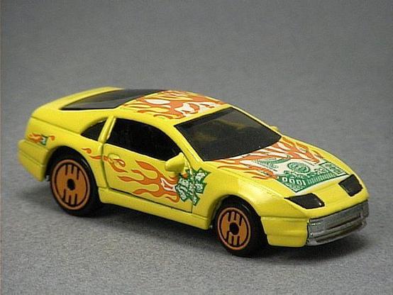 Released in 1993, Metal Flake Black Nissan Custom Z of Revealers with Ultra Hot wheels. Tampo: Green and white $1000 bills and orange and white flames on hood, rood and sides. Packaging: Revealers 10 Pack. Metal Body, Metal Base. Made in Malaysia. Scarcity: 2/10