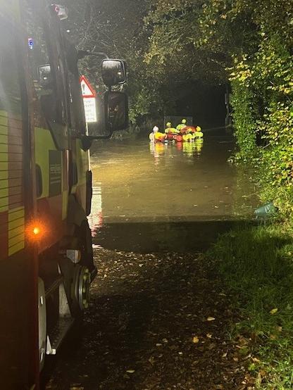 Rescue crews wading through floodwater with dogs during the Glanrhyd Dog Sanctuary rescue near Kidwelly.