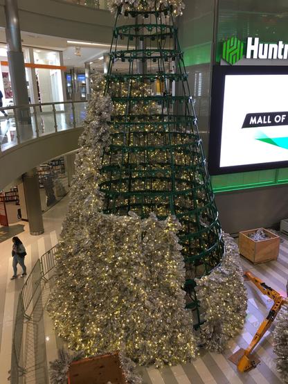 At the "Huntington Bank Rotunda at Mall of America" is erected a two-story-tall holiday tree with lights, all of which must be supplied with electricity somehow.