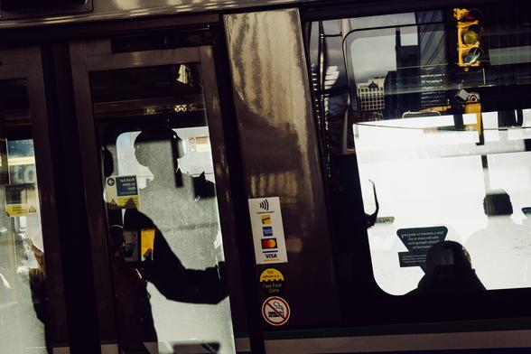 Silhouettes of riders on the bus.