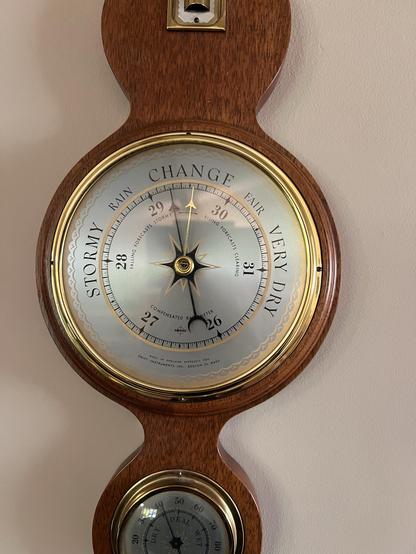 An analog barometer showing that the pressure has dropped about a quarter of a inHG since I last aligned the tracking hand.