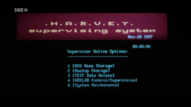a computer monitor shows the main menu of a supervising system called H.A.R.V.E.Y on a space station