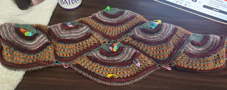 Front view, clue #1, six crescents in four colors - blue-gren, spotted pink, ruby red, pumpkin orange