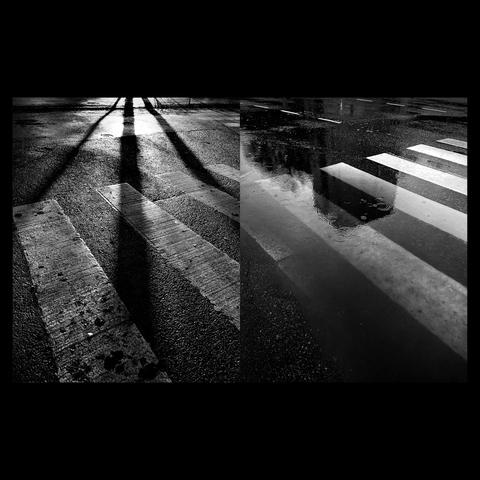 Black and white diptych och photogaphs: left shows shadows falling on a crosswalk in a dark setting, right features wet pavement and a puddle with raindrops reflecting a building.