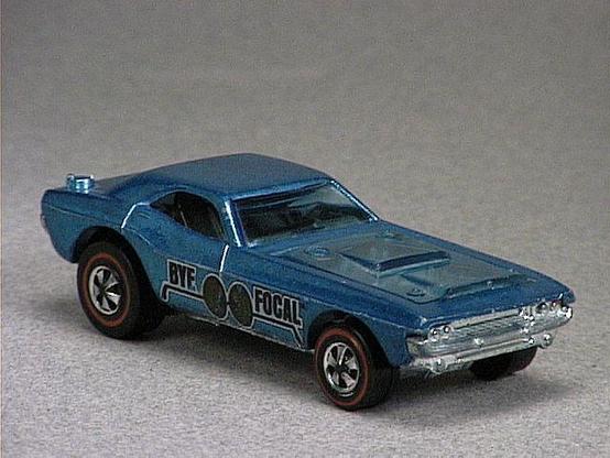 Released in 1971, Spectraflame Aqua Bye Focal of 1971 Hot Wheels with Redline wheels. Notes: Front plastic hood lifts up to reveal two metal engines. Tampo: Black and white on red stickers with 'Bye Focal' and a pair of eyeglasses. Packaging: 1971 Blister. Metal Body, Metal Base. Made in Hong Kong. Scarcity: 6/10