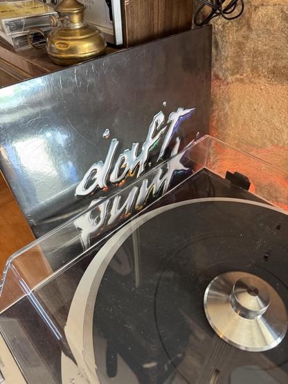 A Daft Punk record next to a vintage turntable