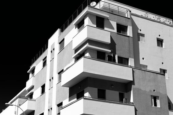 High contrast black and white image of a Bauhaus style apartment building in Tel Aviv Israel.