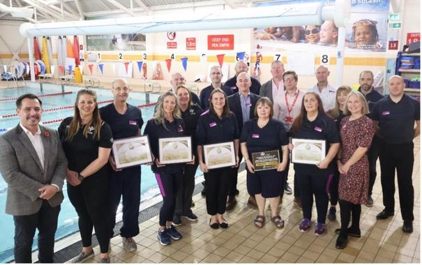 Group photo of Swansea Council, Swim Wales and Freedom Leisure representatives at Penlan Leisure Centre.