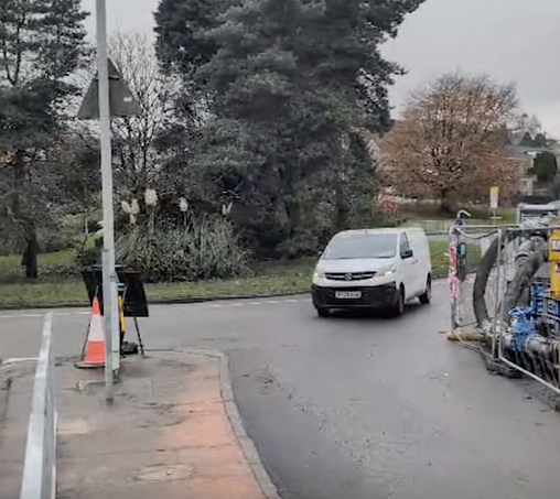 Van driving past pumping equipment at reopened Cwmbwrla roundabout towards Carmarthen Road.