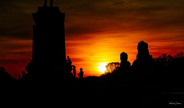 Fiery orange sunset silhouettes the Ulysses S Grant Memorial with seated lion sculpture