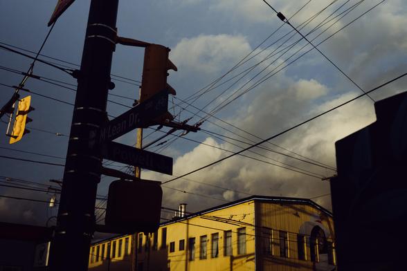Looming clouds move in at a moody intersection.
