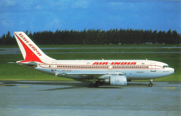 This color postcard shows an Air India Airbus A310-300, registered VT-EJL, taxiing on the runway at an airport bordered by lush green grass and a line of trees in the background. The aircraft displays Air India’s classic red and white livery with its signature palace window motif running along the fuselage and the bold AIR-INDIA titles across the cabin. The red tail fin bears the airline’s name in Hindi and English, a hallmark of Air India’s elegant branding of the late 20th century. The A310’s compact twin-engine design reflects the airline’s modernization during the 1980s and 1990s, when these jets were introduced for medium- to long-haul routes. The image captures both the grace and technological advancement of the national carrier, symbolizing India’s presence in international aviation.