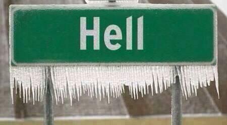 A green street sign festooned with icicles, with white lettering spelling "Hell."