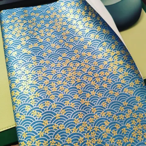 Handmade paper with classic blue seigha pattern featuring gold cherry blossoms.