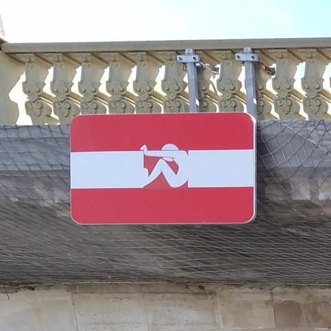 Forbidden navigation sign edited to figure a figure pushing back on both ends of the white band.