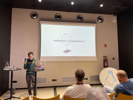 Harry presenting a slide titled “Fediverse x Cooperation”