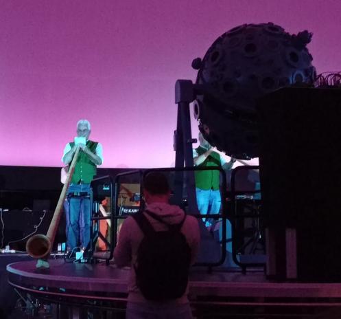 Next to the projector.