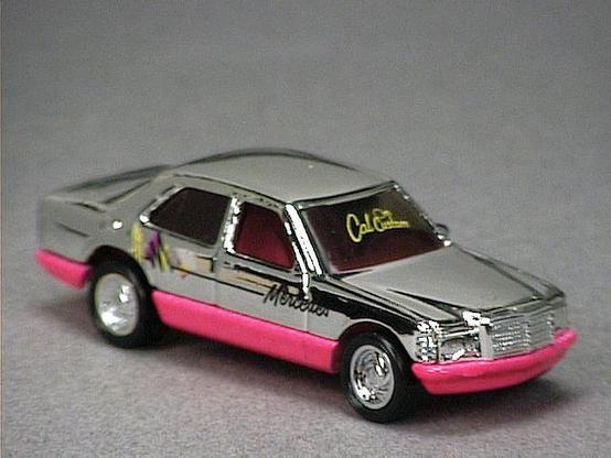 Released in 1990, Chrome Colored Mercedes 380 SEL of California Customs with Turbo wheels. Tampo: Black, yellow and pink on sides with 'Mercedes', 'Cal Custom' in yellow on windshield. Packaging: California Customs Blister. Metal Body, Metal Base. Made in Malaysia. Scarcity: 2/10