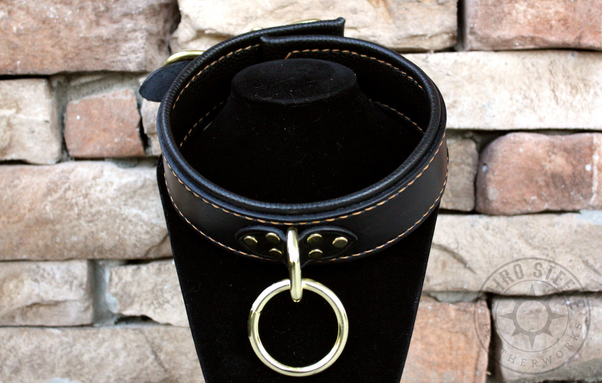 The black and brass collar on a black stand
