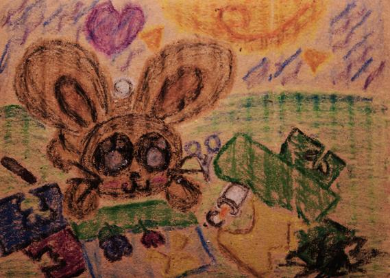 A crayon drawing of a bunny making a construction paper collage in the sun.