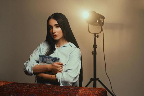 woman holding book in studio lighting setup
