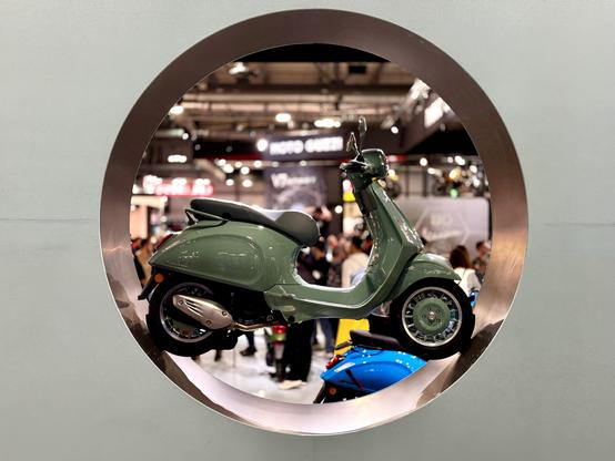Vespa scooter inside a circular cutout in the stand