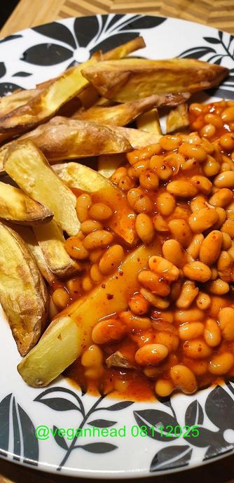 A plate with Air-fried Chips and spiced up Baked Beans and missing from photos is anamma 'VegoSchnitzel' that I ate whilst the chips were cooking
