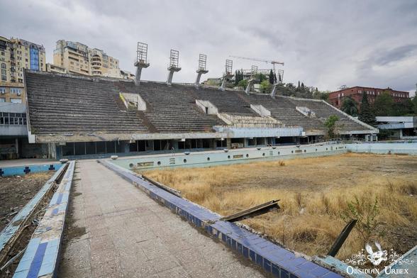 large spectator stand seating area along side of outdoor pool