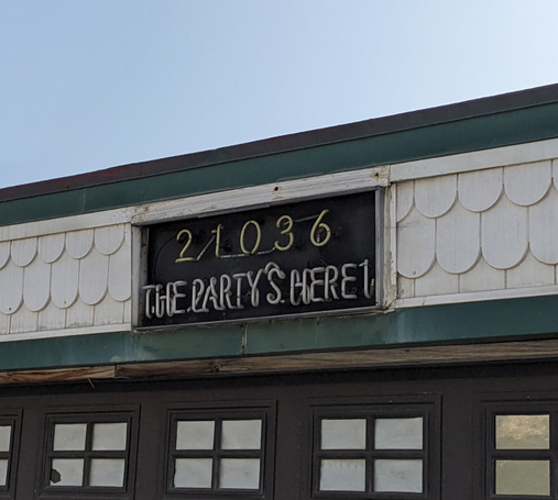 Neon house sign with The Party's Here
