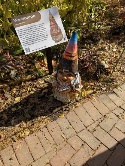 A native American garden gnome in a fall garden