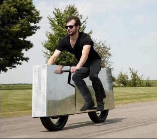 A man drives a stainless steel rectangular box with 2 wheels: Tesla's new Cyberbike.
The rider is not wearing a helmet because of course not. Safety is for the hois pollois, and doesn't apply to him.