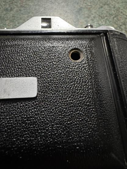 A close up of the front of the Selfix showing a hole that is normally covered by metal screw